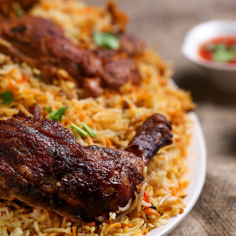 Ein gebratenes Stück Fleisch mit Reis auf einem Teller